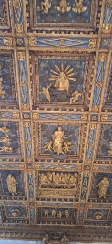 a ceiling of a building with paintings on it at Libera Mente in Fabriano