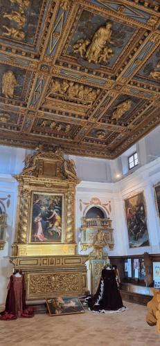 a room with a ceiling with paintings on it at Libera Mente in Fabriano