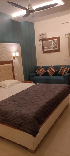 a bedroom with a large bed and a couch at JD Farm and Resorts in Rāi