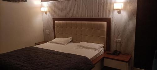 a bedroom with a large bed and two night stands at JD Farm and Resorts in Rāi
