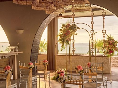 a set up for a wedding in a restaurant with chairs and flowers at Crowne Plaza Fiji Nadi Bay Resort & Spa by IHG in Nadi
