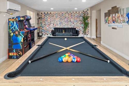 a pool table with balls in a room at 6 Br Resort Style Home Pool Game Room Fire Pit in Glendale