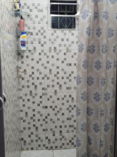 a shower with a shower curtain in a bathroom at Sossego Meu in Soure