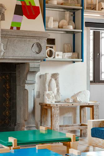 a room with a table and a room with a fireplace at JAM Ghent in Ghent