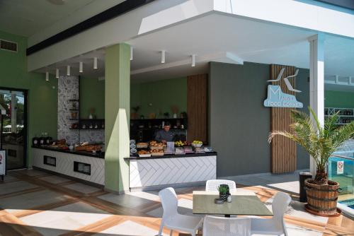 a restaurant with a counter with a table and chairs at Hotel Marvel All Inclusive - FULLY RENOVATED FREE Beach Access in Sunny Beach