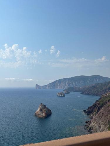 a large body of water with two rocks in it at Casa Vacanza il Mandorlo in Domusnovas