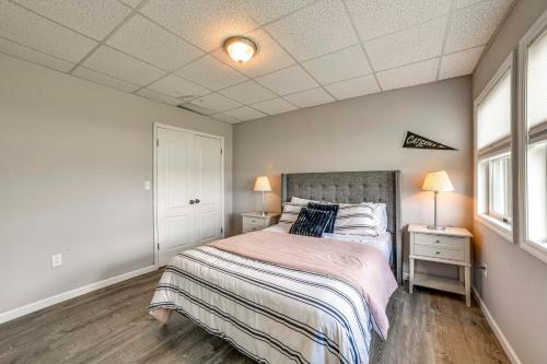 a bedroom with a bed and two night stands and two lamps at Pet-Friendly Catskills Home with Serene Pond! in Jefferson