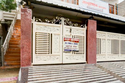 a building with a gate with a sign on it at Hotel O Ayushman in Jabalpur