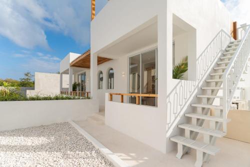 a house with white walls and stairs at Villa Valli 8, Luxury Mediterranean Villa Bingin in Uluwatu