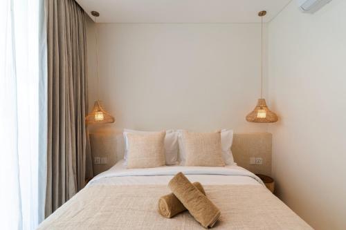 a bedroom with a bed with two towels on it at Villa Valli 8, Luxury Mediterranean Villa Bingin in Uluwatu