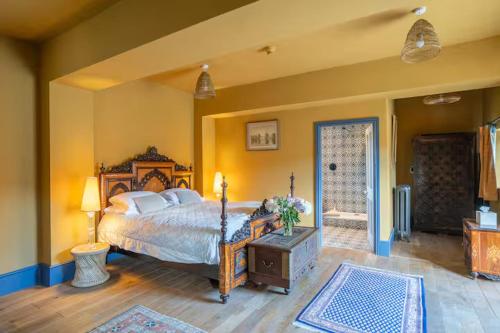 a bedroom with a large bed and a door to a patio at Llanerchydol Hall Suites in Welshpool