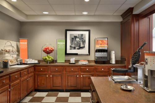 a large kitchen with wooden cabinets and a counter top at Hampton Inn & Suites Middletown in Middletown