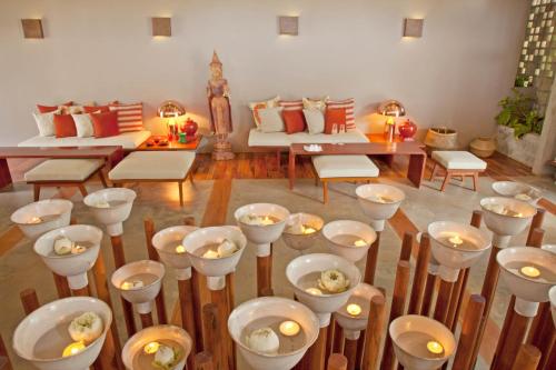 a room with white bowls with candles in it at Templation Hotel in Siem Reap