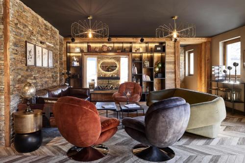 a living room with two chairs and a couch at Chalet Alpen Valley, Mont-Blanc in Combloux