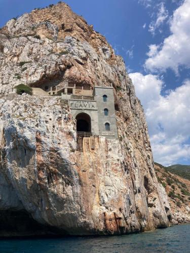 a building on the side of a rock cliff at Casa Vacanza il Mandorlo in Domusnovas