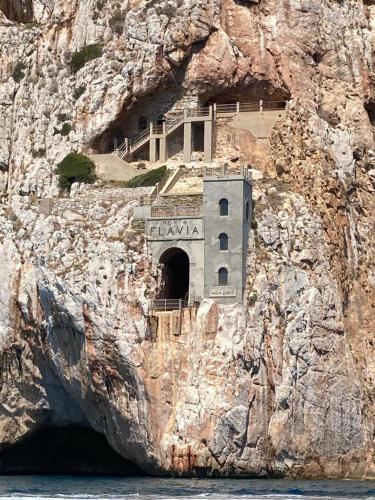 a building on the side of a cliff at Casa Vacanza il Mandorlo in Domusnovas