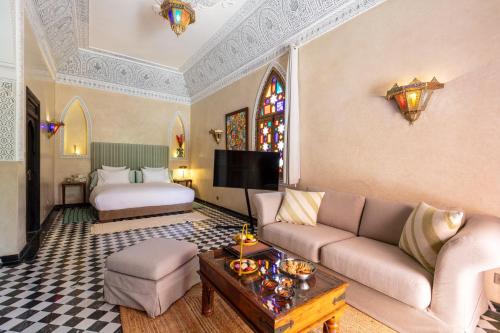 a living room with a couch and a bed at L Mansion Villa in Najem