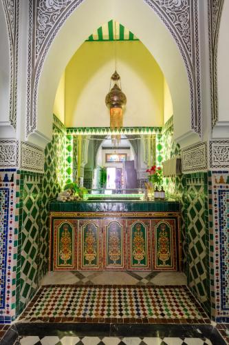an ornate room with a wooden table in a building at L Mansion Villa in Najem
