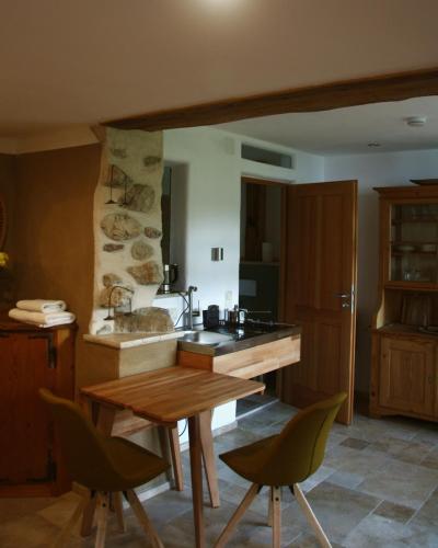 a kitchen with a sink and a table and chairs at Ferienwohnung Rechler in Frasdorf