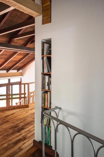 a bookshelf in the corner of a room at Casa d'Abreu Neto - Siza's First Work in Matosinhos