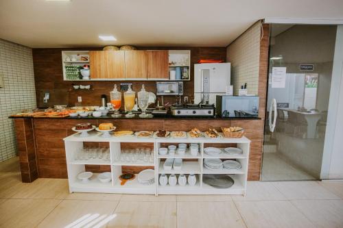 a kitchen with a counter with food on it at Pousada Aconchego Noronha in Fernando de Noronha