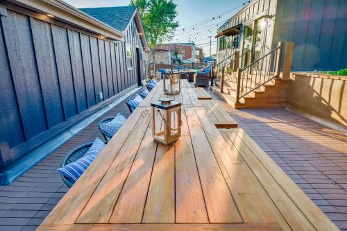 a long wooden table on a deck with benches at The Cove Guest House in Prescott
