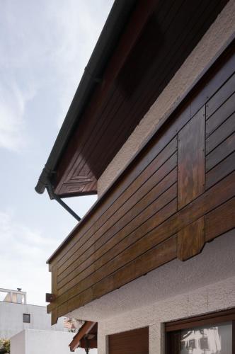 a house with wooden panels on the side of it at Casa d'Abreu Neto - Siza's First Work in Matosinhos