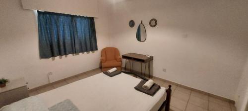 a hospital room with a bed and a chair at Magic Sea Apartments in Larnaka