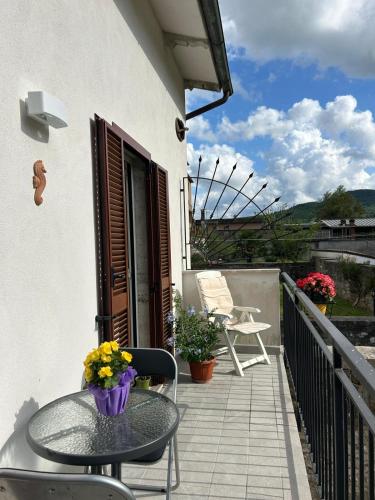 a patio with a table and chairs on a balcony at Piediluco House - La Casa di Caio in Piediluco