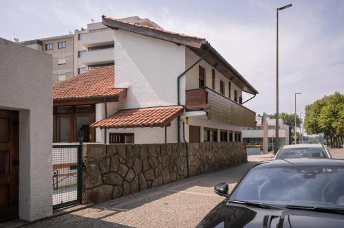a car parked in front of a house at Casa d'Abreu Neto - Siza's First Work in Matosinhos