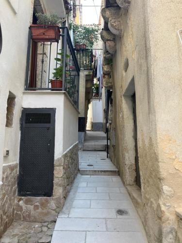 an alley with stairs and a door and a balcony at La Casetta in Ischitella