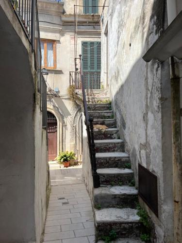 an alley with stairs leading up to a building at La Casetta in Ischitella