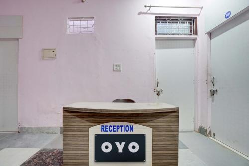 a reception desk in a room with a registration sign at Hotel O RED ROSE HOTEL in Alwar