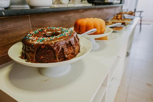a chocolate cake on a plate on a counter at Pousada Aconchego Noronha in Fernando de Noronha