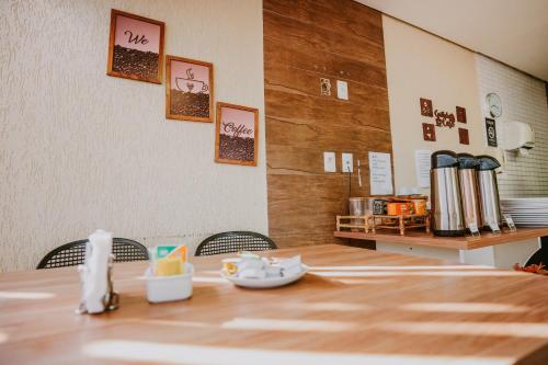 a dining room with a table and a counter at Pousada Aconchego Noronha in Fernando de Noronha