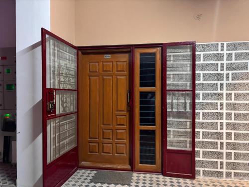 a pair of wooden doors in a building at Samuels Comfort Homes in Bengaluru