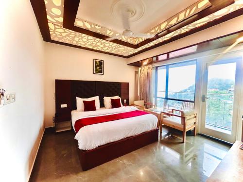 a bedroom with a bed and a large window at Edge Dwapar A Luxury Property Near Mall Road in Mussoorie