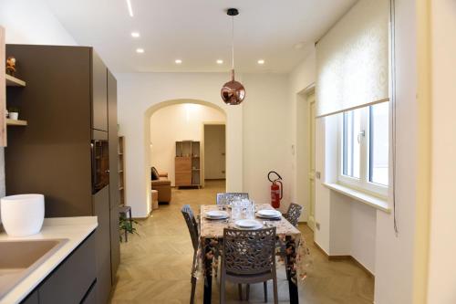 a kitchen and dining room with a table and chairs at La casa di Nonna Afra in Agerola