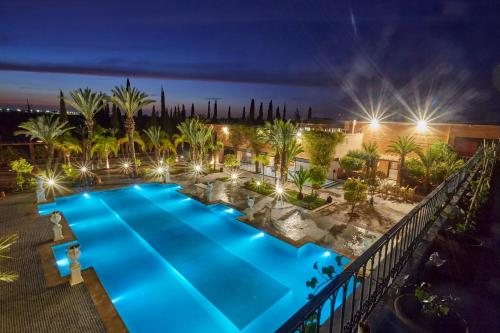an overhead view of a pool at night at L Mansion Villa in Najem