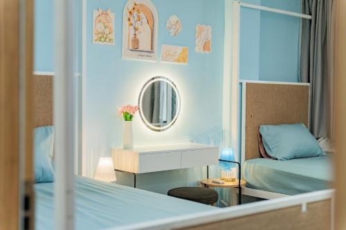 a small bedroom with a bed and a mirror at Aluna Residence Homestay in Da Nang