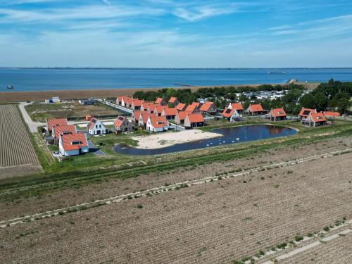 an aerial view of a row of houses near the water at Hello Zeeland - vakantiewoning Knuitershoek 86 in Kloosterzande
