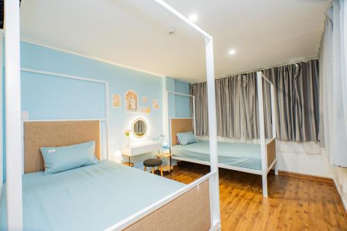 a bedroom with two beds and a bunk bed at Aluna Residence Homestay in Da Nang