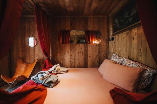 a bedroom with a bed with a stuffed animal on it at Chalet SALOON avec SPA privatif in Le Biot