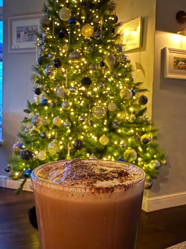 a drink in front of a christmas tree at Sids restaurant and bar with rooms in Cardiff