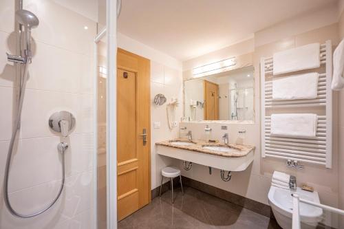 a bathroom with a sink and a shower and a toilet at Garni Crepaz in Selva di Val Gardena