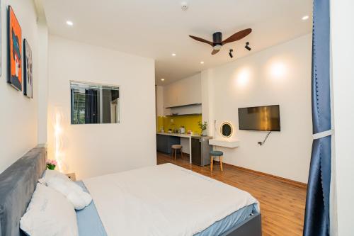 a bedroom with a large bed and a desk at Aluna Residence Homestay in Da Nang