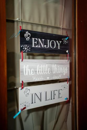 a sign that says enjoy the little things in life at RedBlue Door Two Traditional Listed Houses in Pano Lefkara