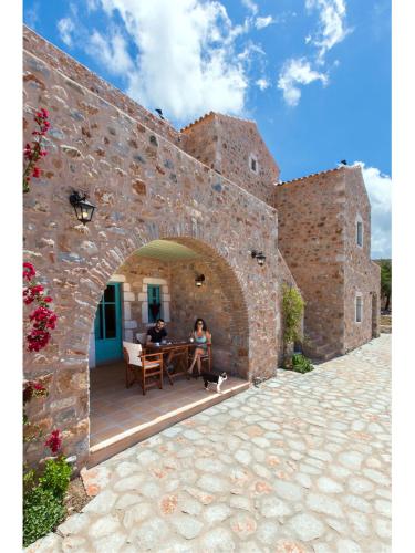 two people sitting at a table inside of a building at Pandora in Pirgos Dhirou