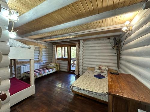 a room with two bunk beds and a table at Під Горбком in Bukovets