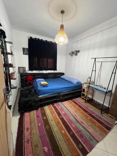 a bedroom with a bed and a rug at Homey vibes in Agadir
